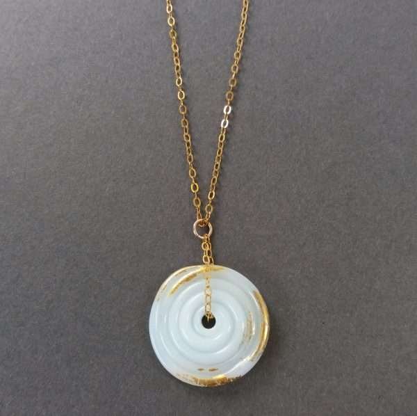 Pale blue and gold disc pendant on gold chain