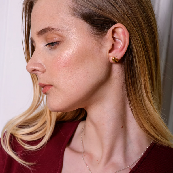 Model wearing stud earrings