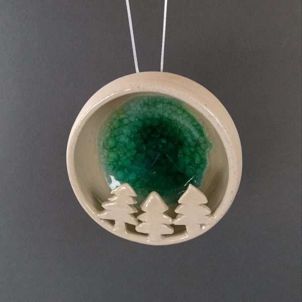 Round ceramic bauble with trees inside and green fused glass