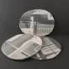 Three white and grey parian porcelain coasters on grey background