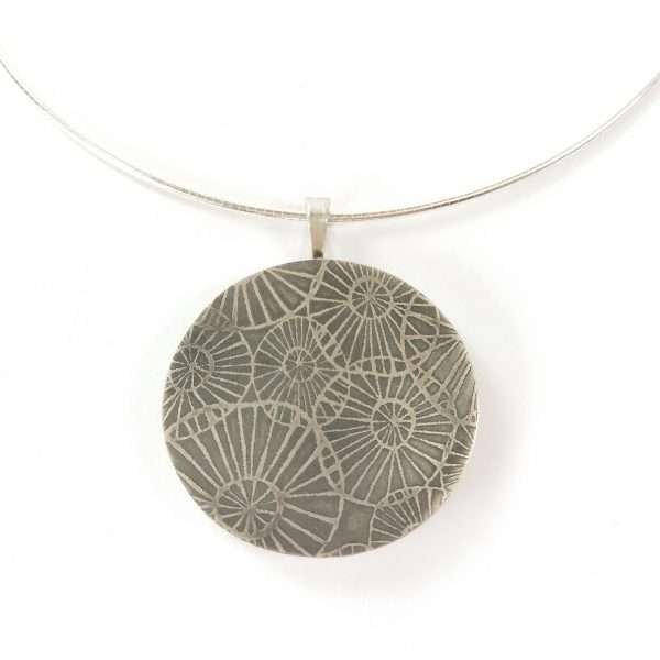 Silver pendant with etched details