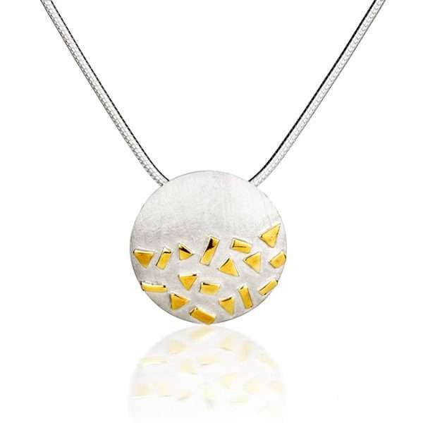 Silver and gold pendant on white background