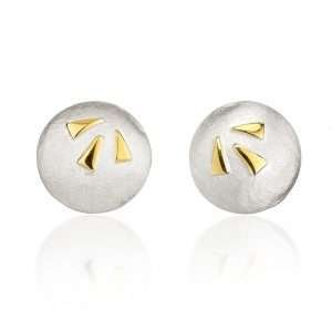 Silver and gold studs on white background