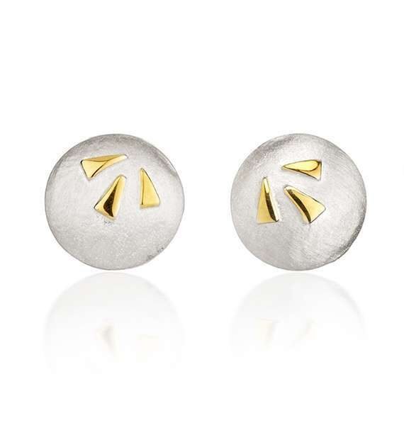 Silver and gold studs on white background