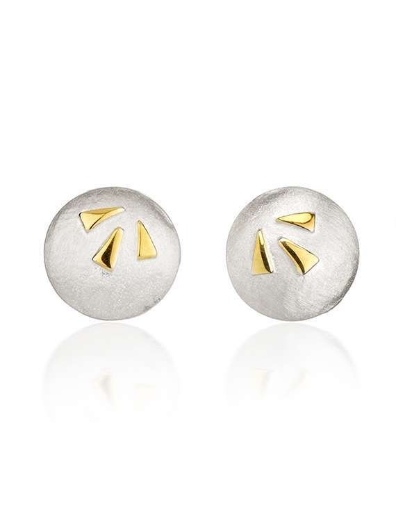 Silver and gold studs on white background