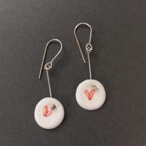 Round porcelain earrings with heart design