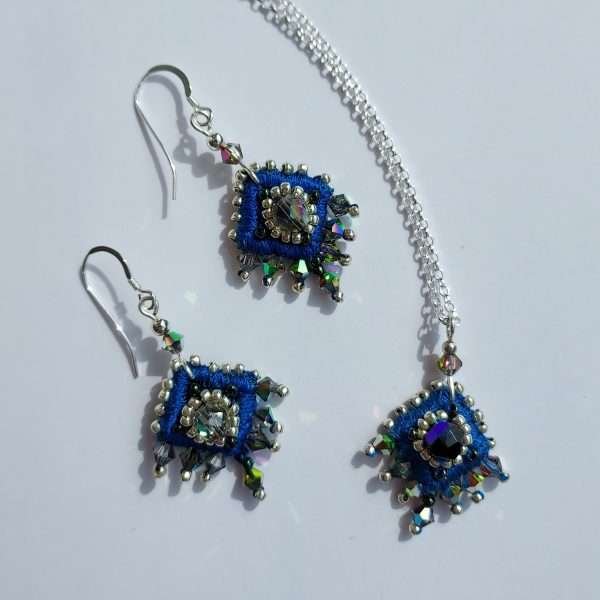 Set of blue embroidered earrings and matching pendant on silver chain
