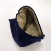 Inside green pattern fabric of navy fabric pouch with zip closure