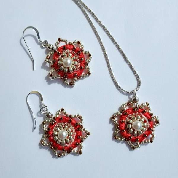 Set of coral coloured embroidered flower earrings and necklace