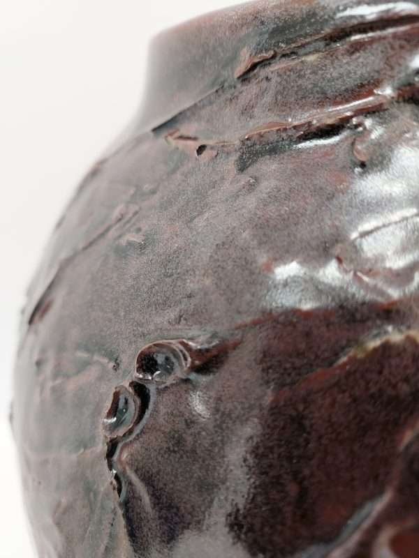 Detail of large brown thrown ceramic earthenware jar