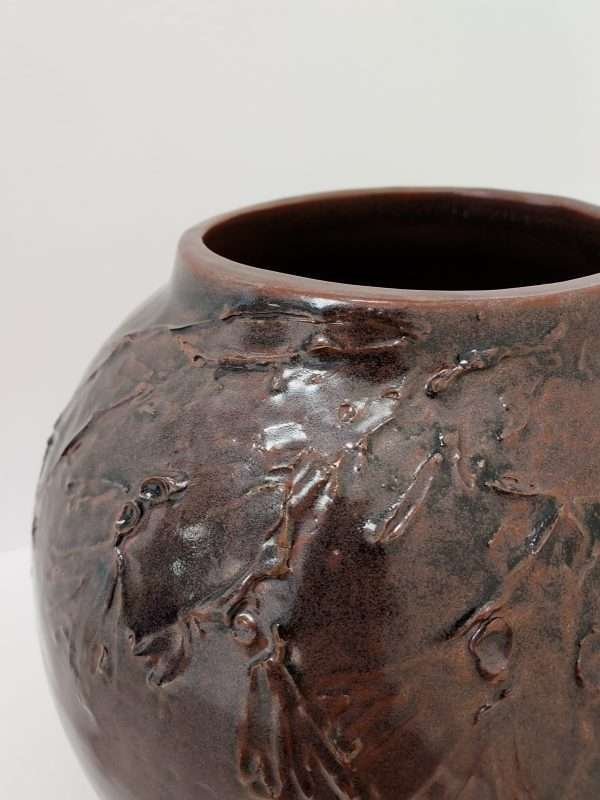 Detail of large brown thrown ceramic earthenware jar