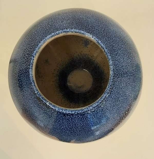 Top view of inside a round blue ceramic jar