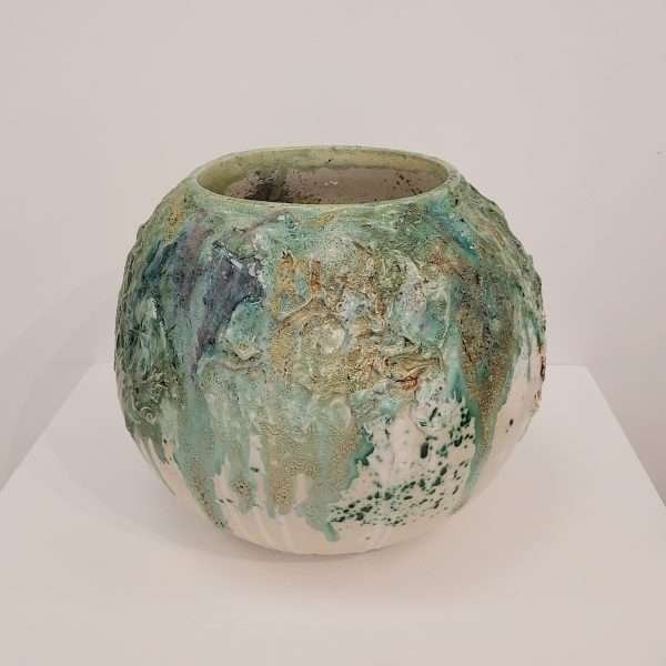 Earthenware round jar with various green glazes