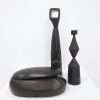 Collection of ebonised ash sculpture, candle stick and box