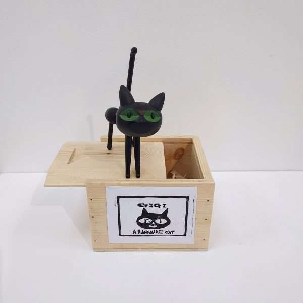 Black wooden cat on box