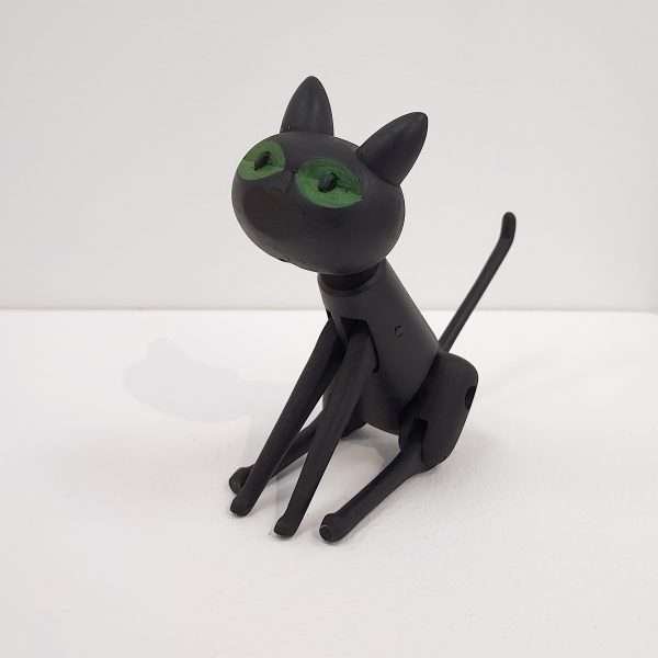 Handmade black wooden toy cat sitting
