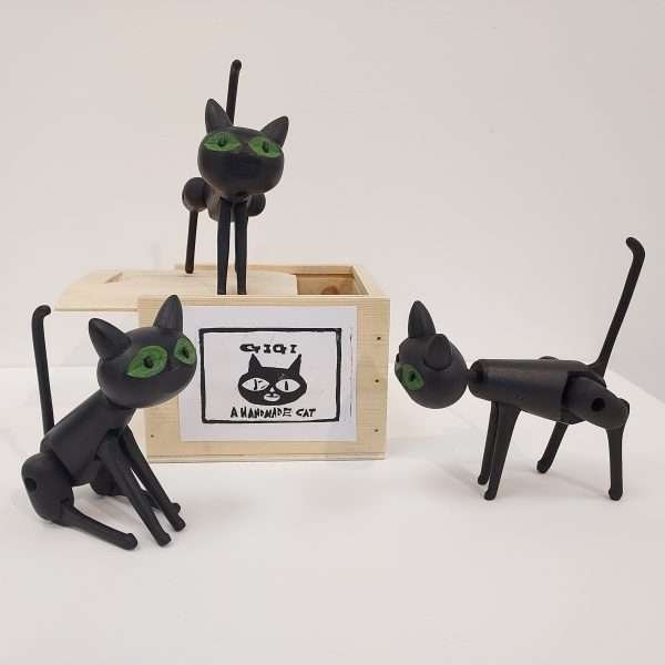 Collection of three black wooden toy cats with box