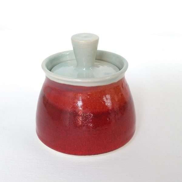 tiny red ceramic jar