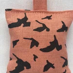 Pink linen lavender sachet printed with a starling pattern in black
