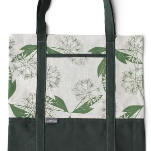 A linen tote bag with a wild garlic pattern printed in green and dark green handles and base