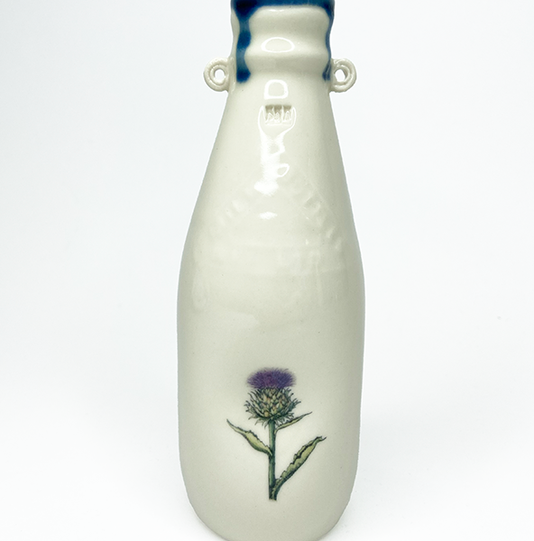Porcelain milk bottle with plant